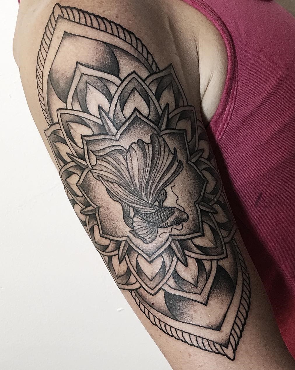 Tattoo Artist Alan Lott created this Beta Fish Mandala Upper Arm Tattoo in Black and Grey at Tattoo Studio and Art Gallery Sacred Mandala Studio in Durham, NC.